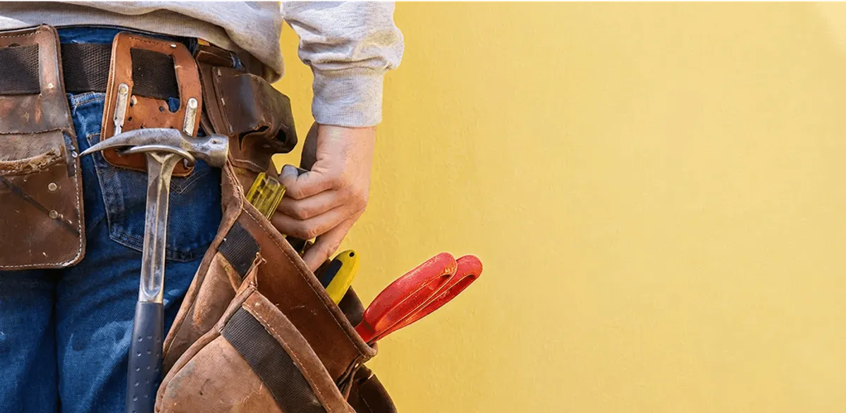 Handyman with tool belt ready for home repairs and maintenance in Saint Petersburg, FL