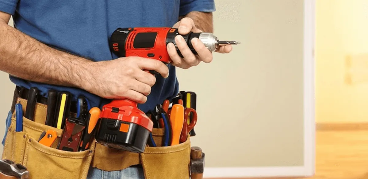 Handyman holding a power drill for home repairs and installations in Saint Petersburg, FL